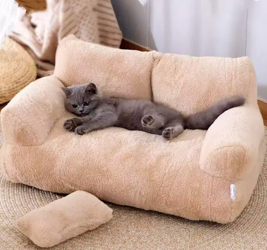 Cat lying on a plush beige pet bed in a cozy room.