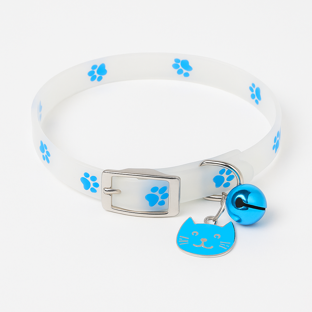 White dog collar with blue paw prints, a bell, and a cat-shaped tag on a white background